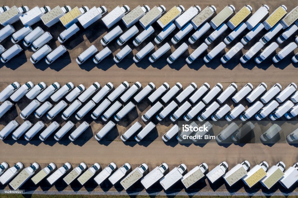 White delivery vans viewed directly from above.